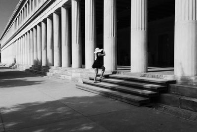 Woman on steps at historic stoa of attalos