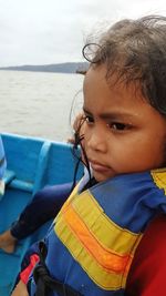 Portrait of girl looking at sea