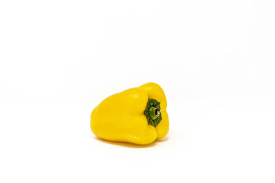 Close-up of yellow fruit against white background