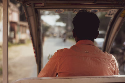 Rear view of man sitting in train