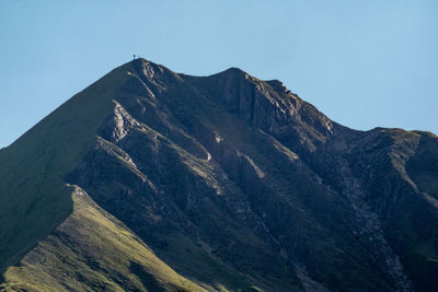 Low angle view of mountain range against clear sky