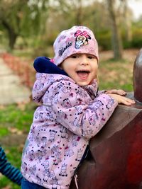 Portrait of smiling boy by railing 