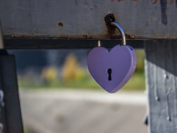 Close-up of padlocks hanging on railing