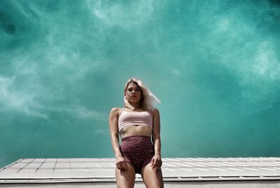 Woman sitting in swimming pool