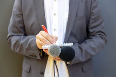 Midsection of man holding umbrella