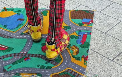 Low section of man standing on doormat