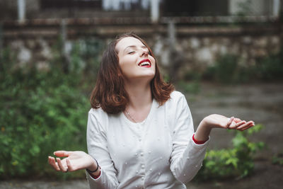 Young woman smiling in the rain