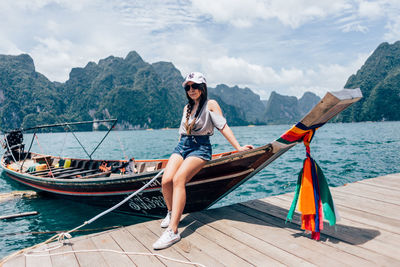 Full length of young woman on boat against sea