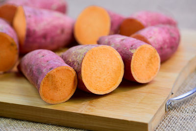 Closeup cut of raw sweet potato on cutting board