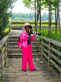 Full length of woman standing on footbridge