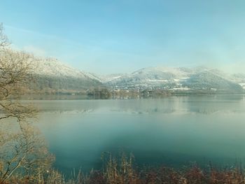 Scenic view of lake and mountains against sky