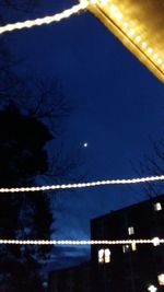 Low angle view of moon against blue sky