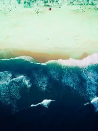 High angle view of rocks by sea against sky