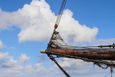 Sailing ship mast against the blue sky on some sailing boats with rigging details