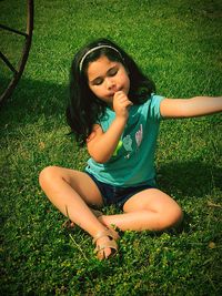 Smiling young woman sitting on field