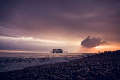 Scenic view of beach against sky during sunset