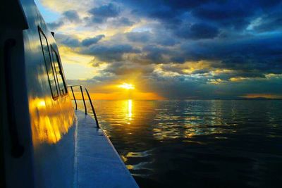 Scenic view of sea against cloudy sky at sunset