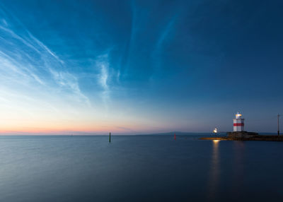 Lighthouse with dramatic sunset sky