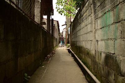Walkway amidst buildings in city