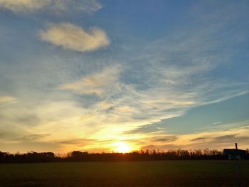 Scenic view of field against sky during sunset