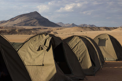 Tent in desert against sky