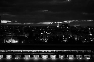 Illuminated cityscape against sky at night