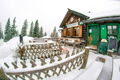 Panoramic view of snow covered chairs against sky