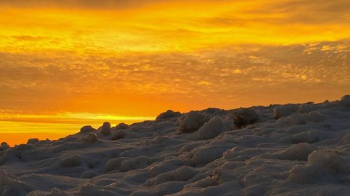 Scenic view of land against sky during sunset