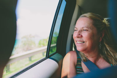 Smiling woman traveling in car