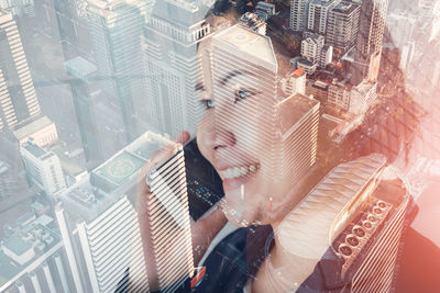 High angle view of woman looking at modern buildings in city