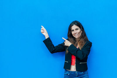 Woman standing against blue background