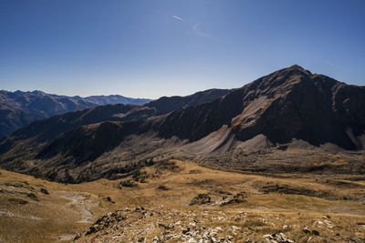 Scenic view of mountains against clear blue sky