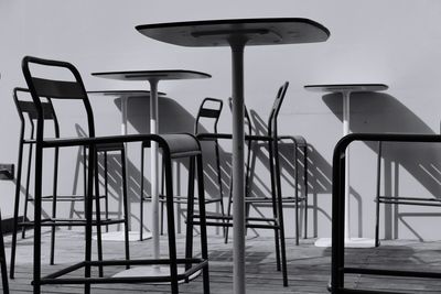 Empty chairs and tables arranged in cafe