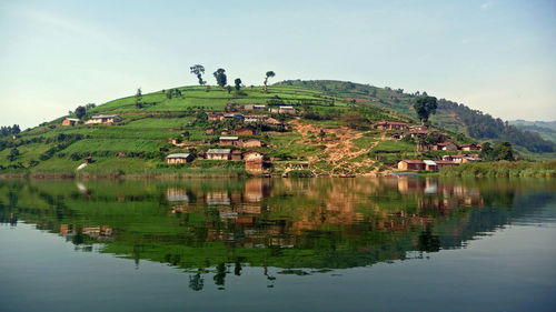 Scenic view and reflection of lake bunyonyi against sky