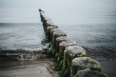 High angle view of wooden posts in sea