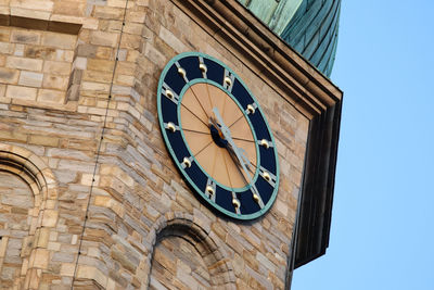 Low angle view of clock tower against sky