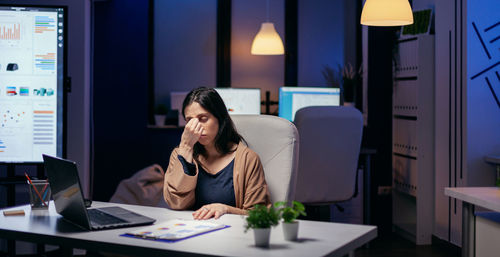 Depressed businesswoman sitting at office