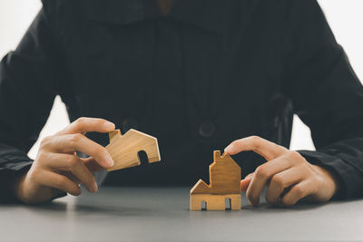 Close-up of hand holding toy against house