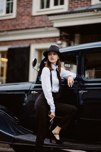 Portrait of young woman sitting in car