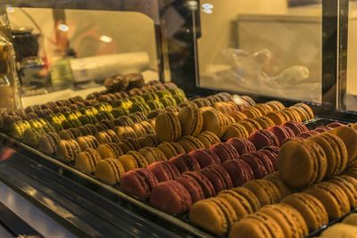 Close-up of macaroons in display cabinet