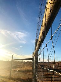 Fence on field against sky