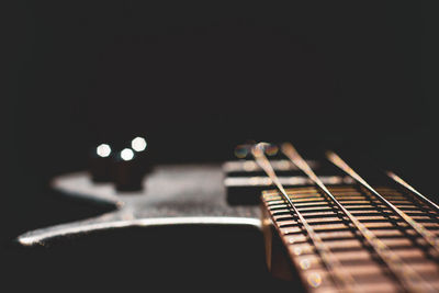 Close-up of guitar against black background