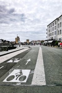 View of city street and buildings against sky