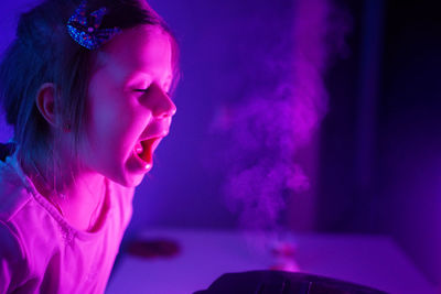 Girl smells the aroma from the slow cooker