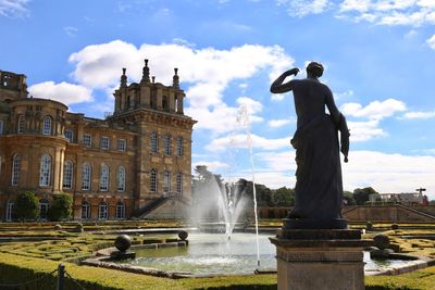 Statue of fountain in front of building