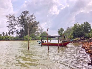 Boat in river against sky