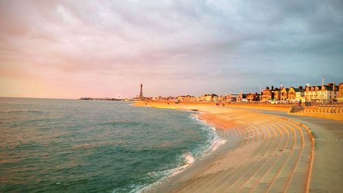 Scenic view of beach against sky during sunset