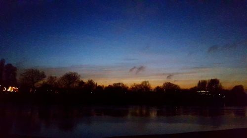 Scenic view of river at sunset