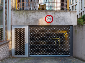 Information sign on fence against building