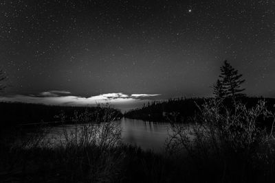 Scenic view of lake against sky at night